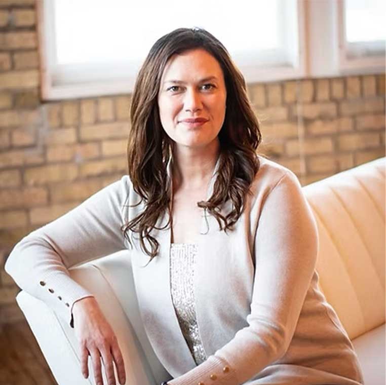 Smiling woman sitting on a small sofa